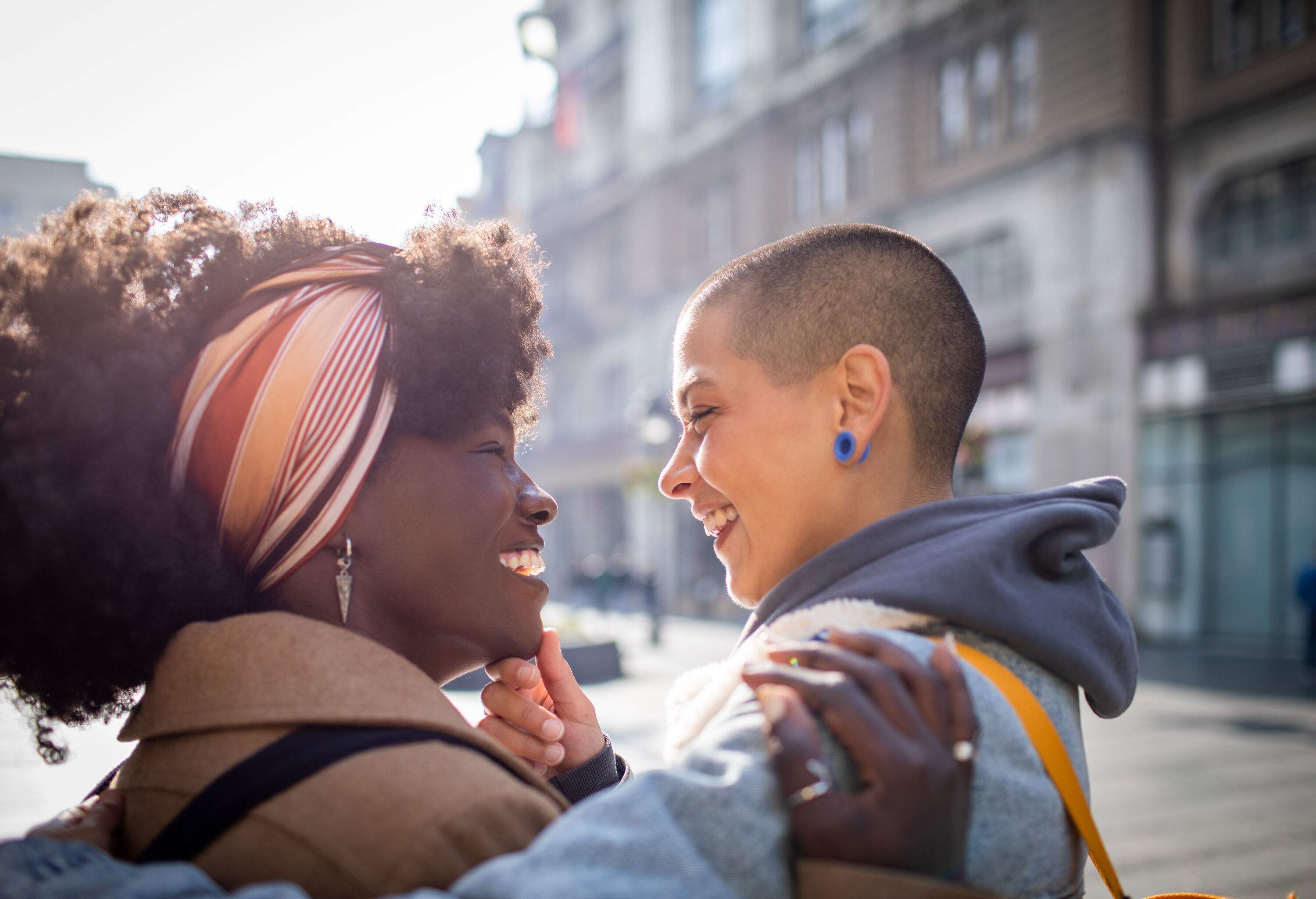 A young female couple smiling at each other.