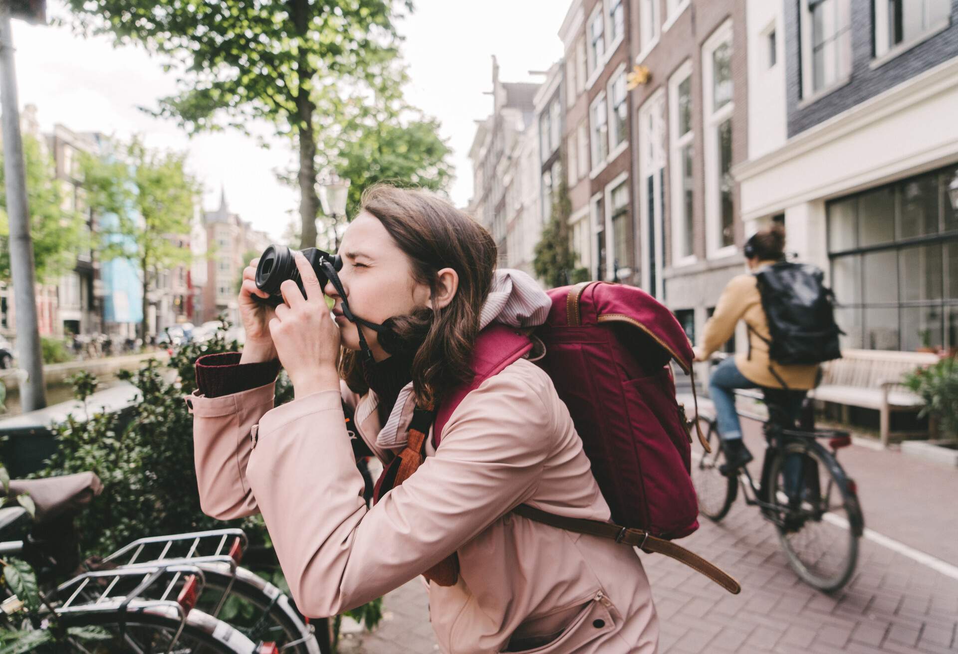 Young Caucasian woman taking photo on the streets  of Amsterdam