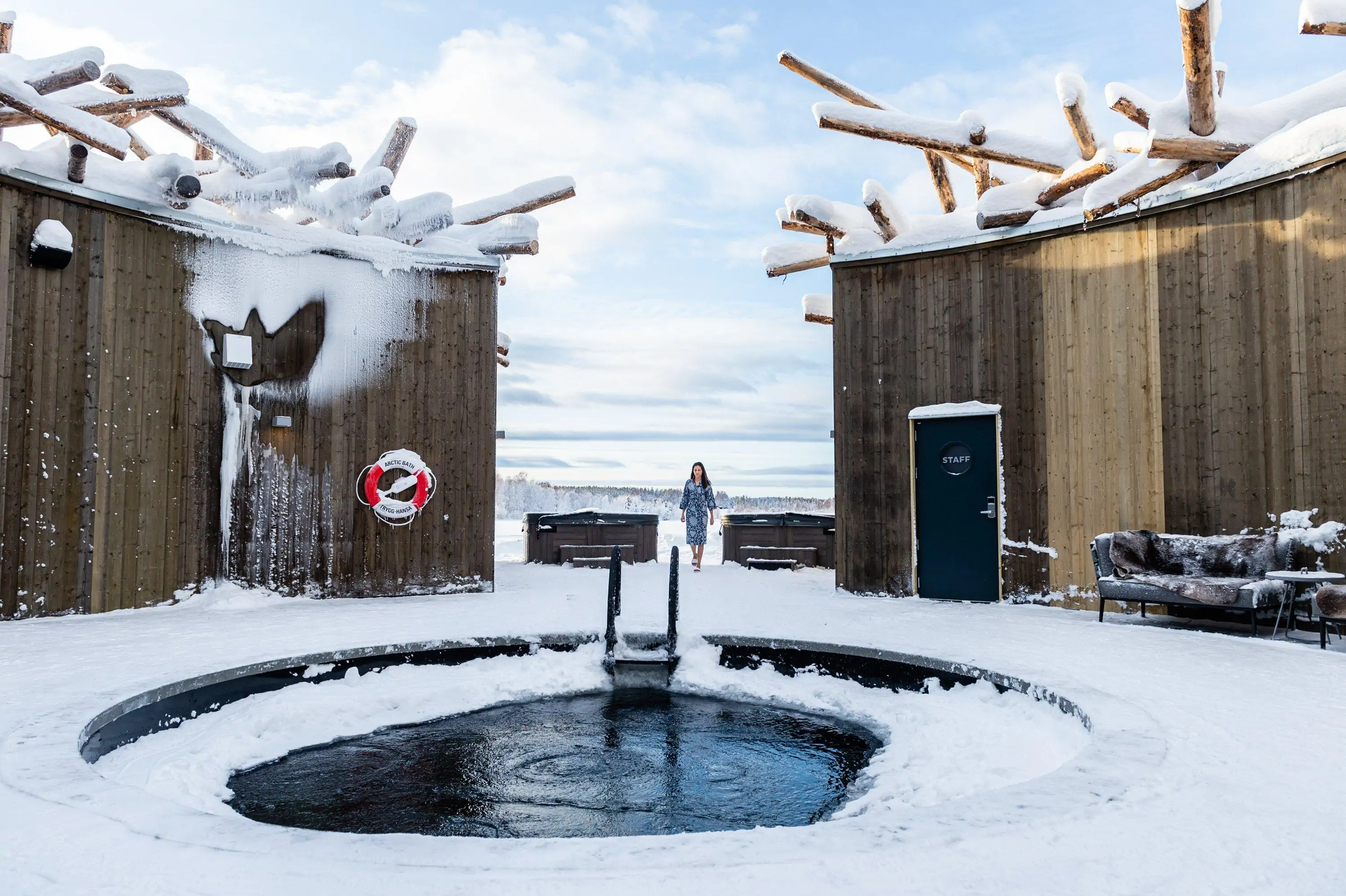 Modern hotel exterior on a snowy day with ice plunging pool