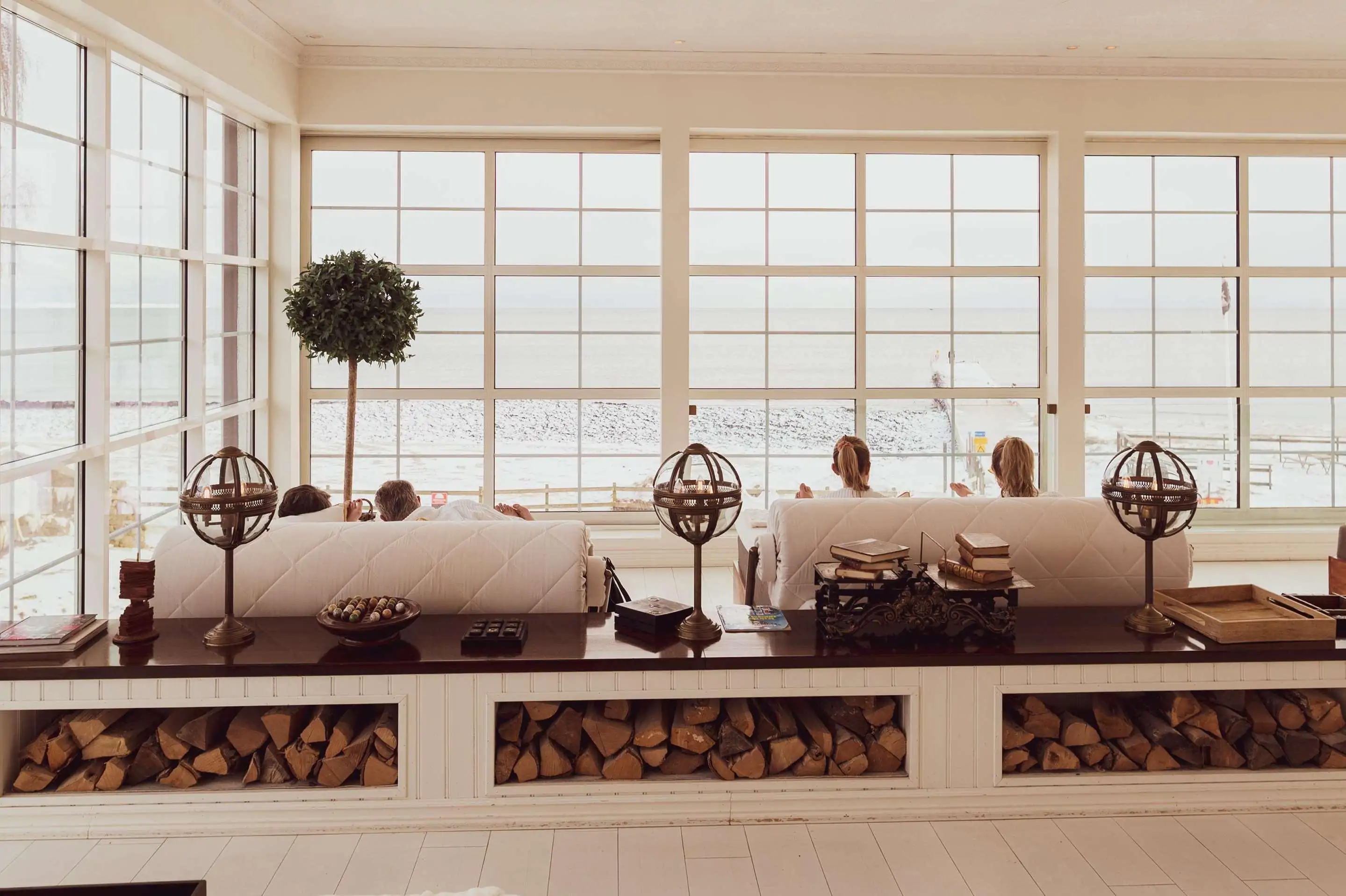 View of a closed veranda overlooking the sea with spa hotels customers relaxing at enjoying the tranquil view