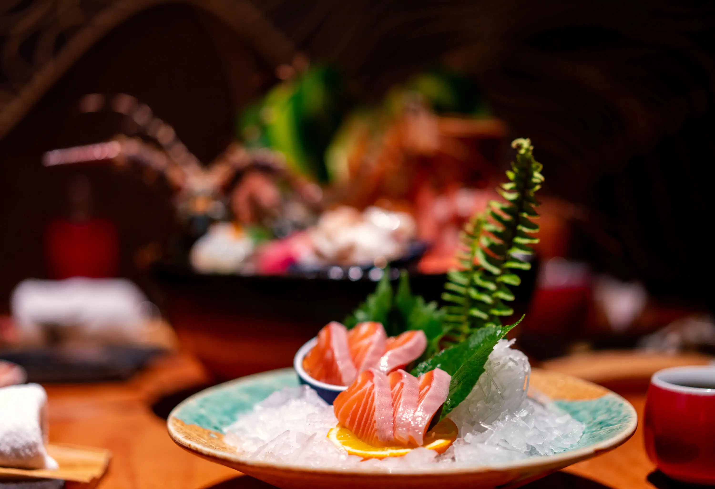 Close-up image of slices of sashimi on an ice plate.