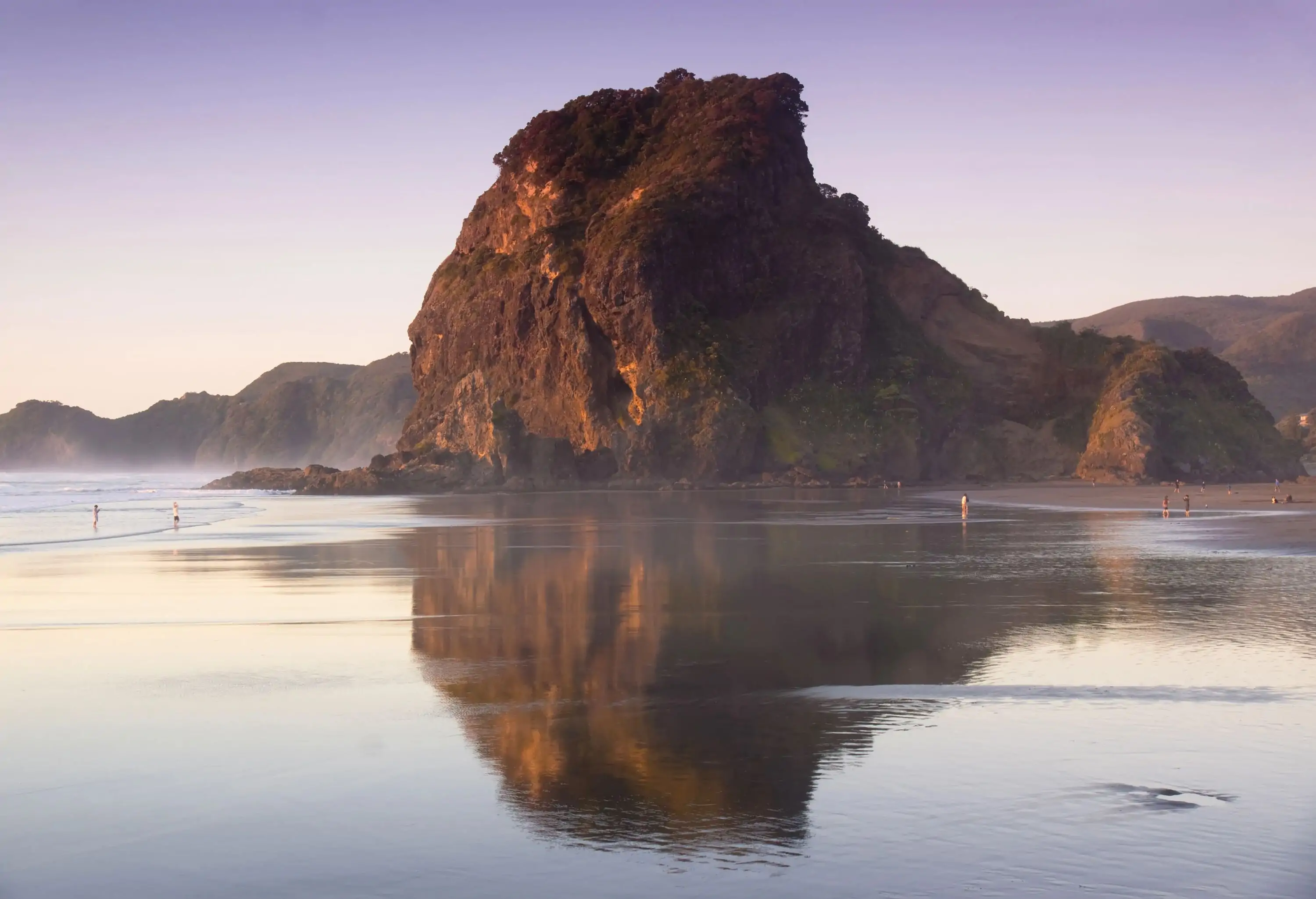 Lion Rock, a magnificent rock formation resembling a resting lion, stands proudly by the beach.