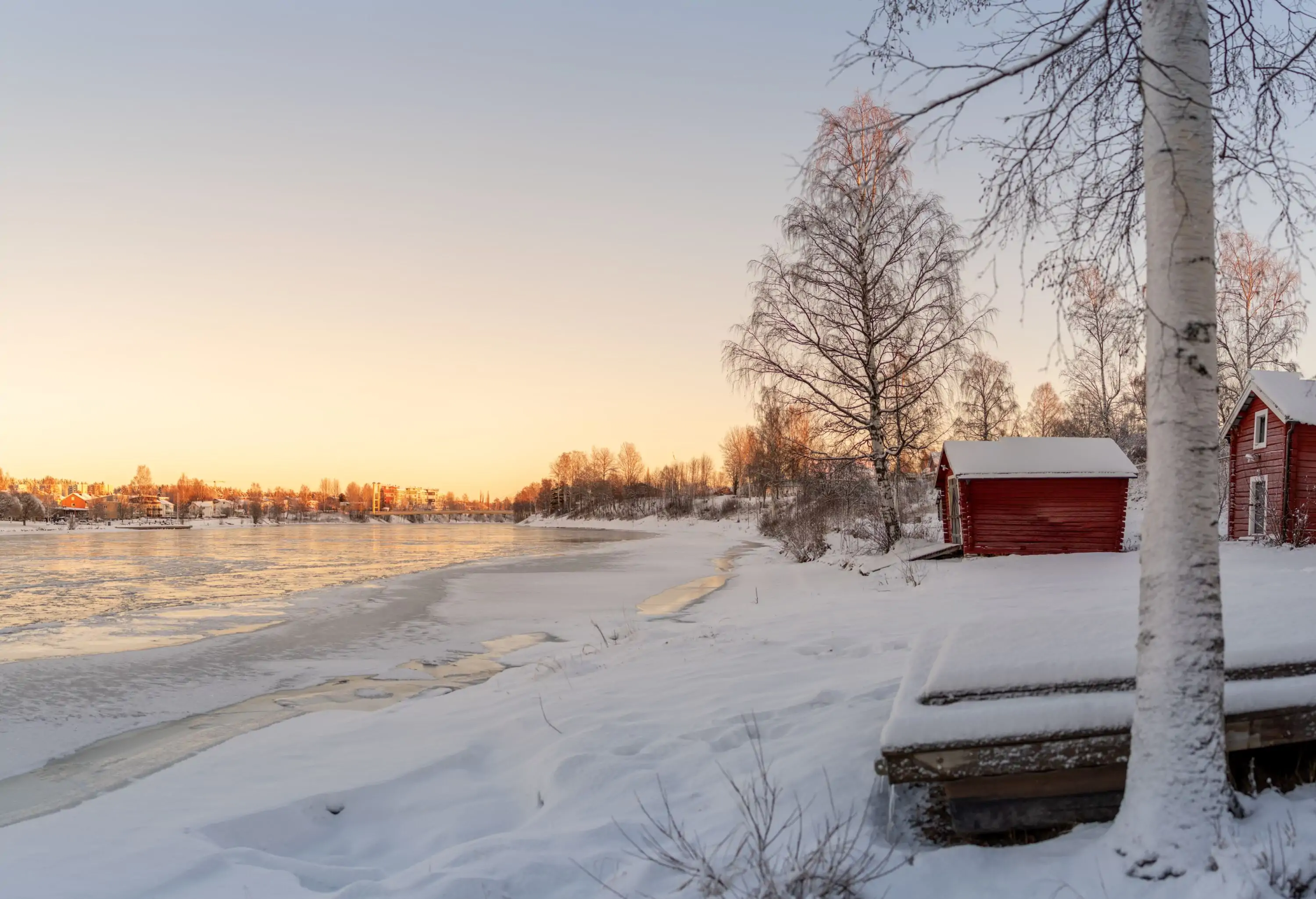 Winter landscape in the Nordics with snow and river at dawn or dusk