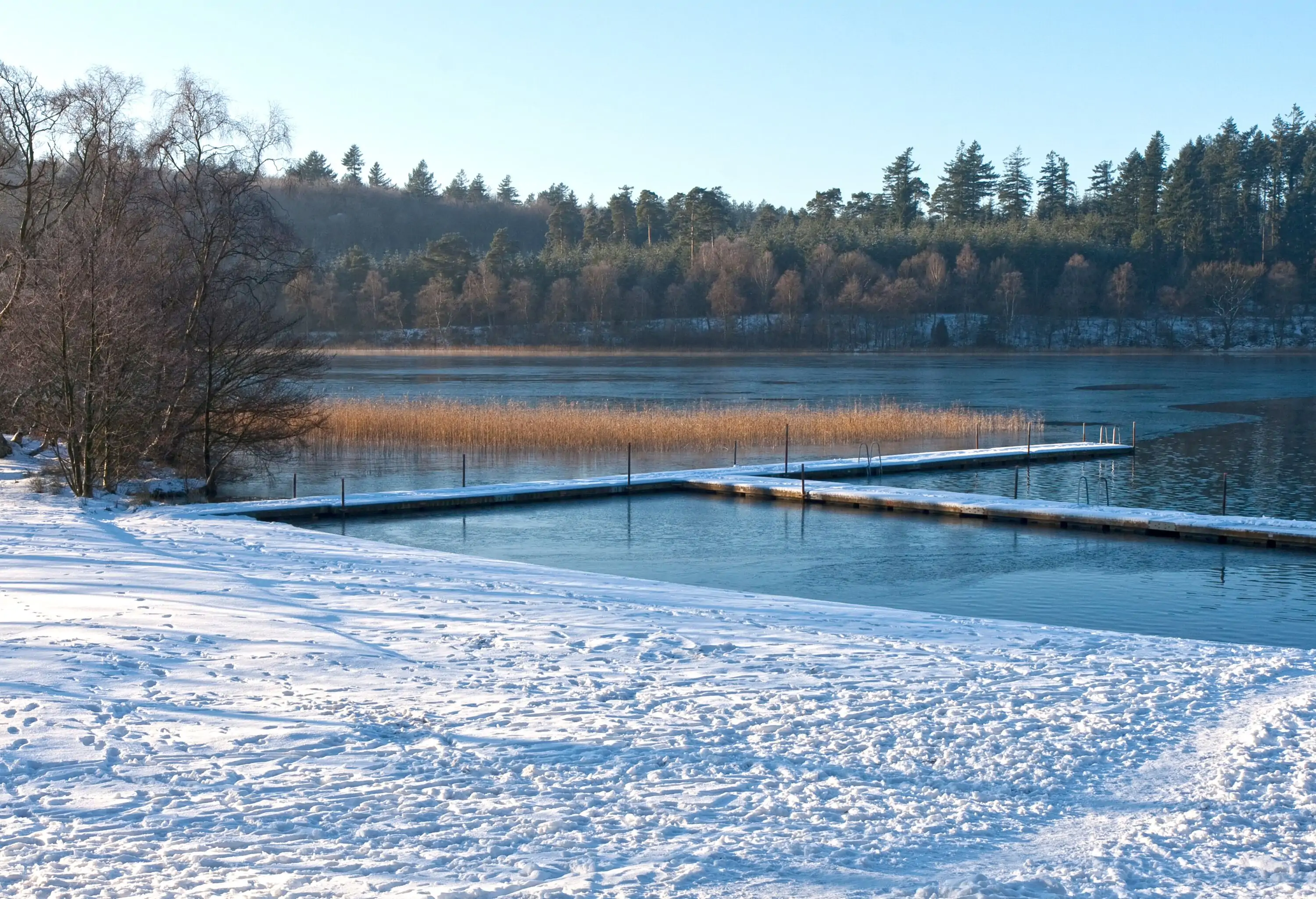 Bathing jetty covered with snow. Shot from Lake Almind, Silkeborg, Denmark