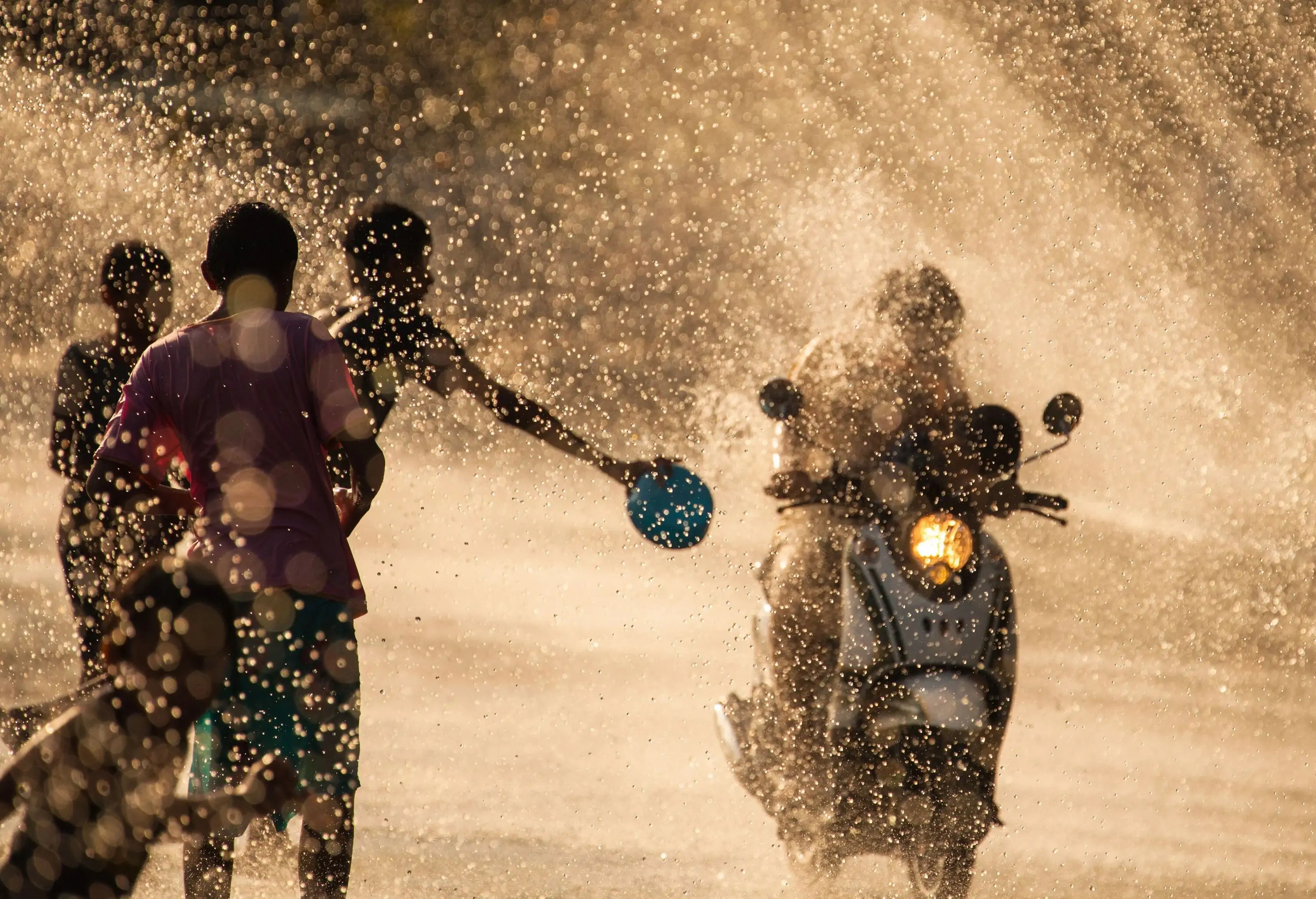 The horizontal image of people enjoying water splashing to each other in the water tunnel during Songkran Festival in Chanthaburi Province of Thailand.