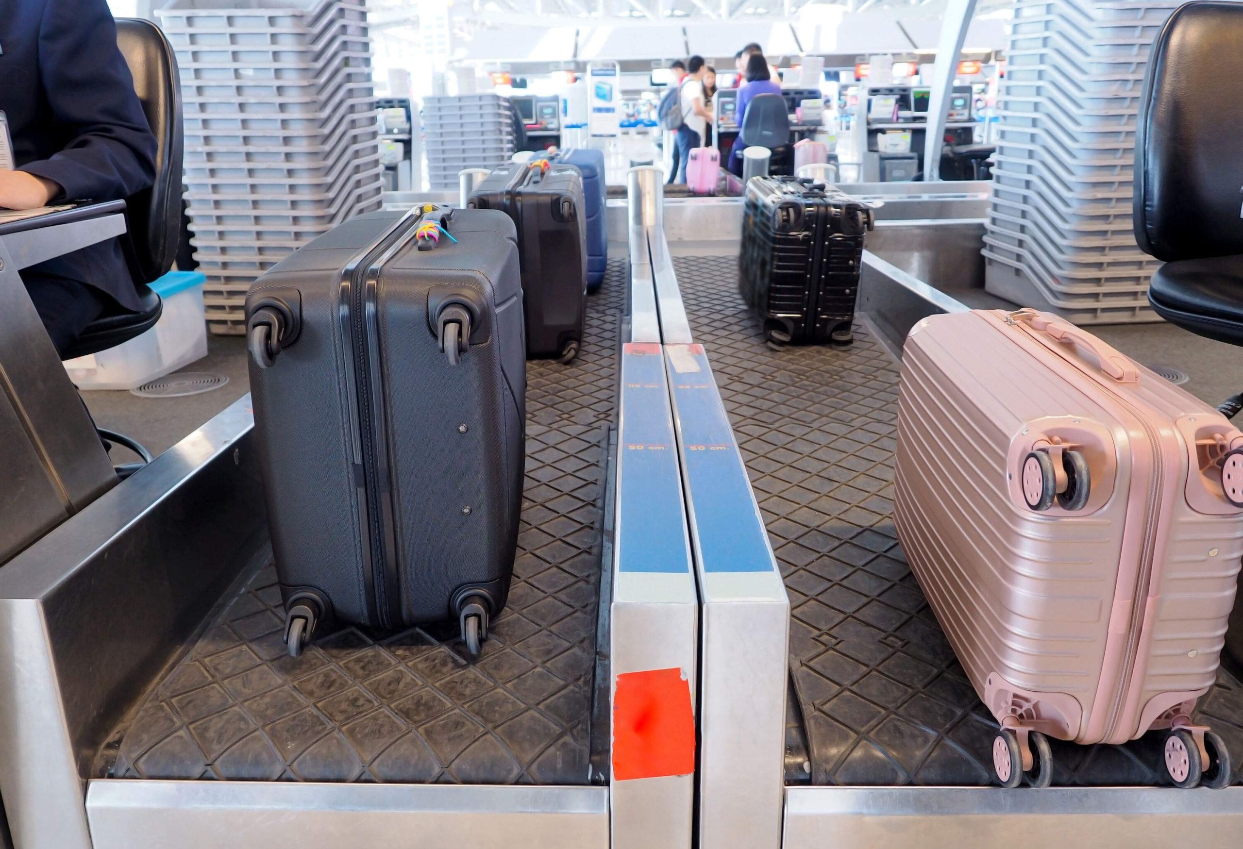 Colourful pieces of luggage checked in at the baggage counter.