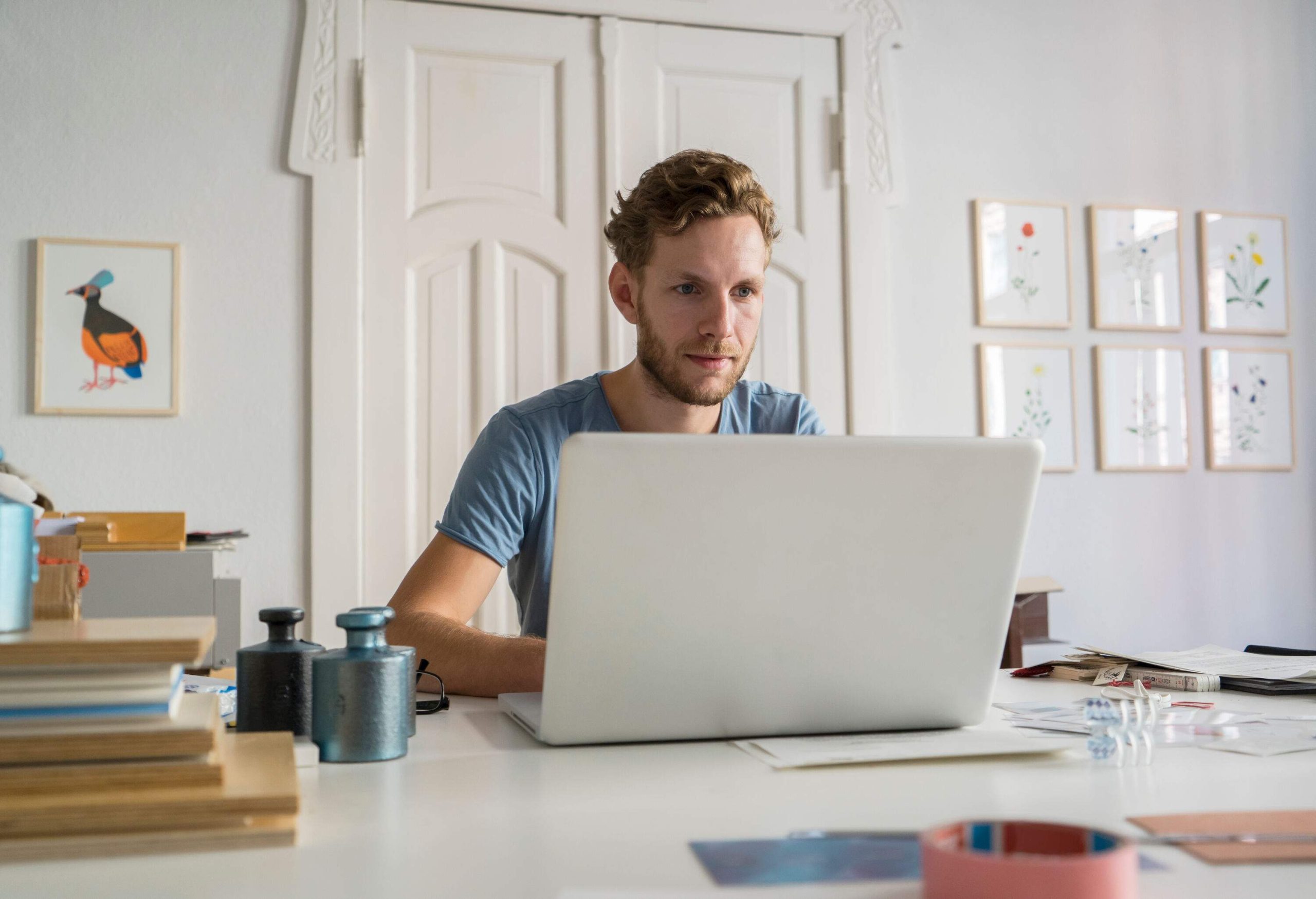 a man sitting by his laptop