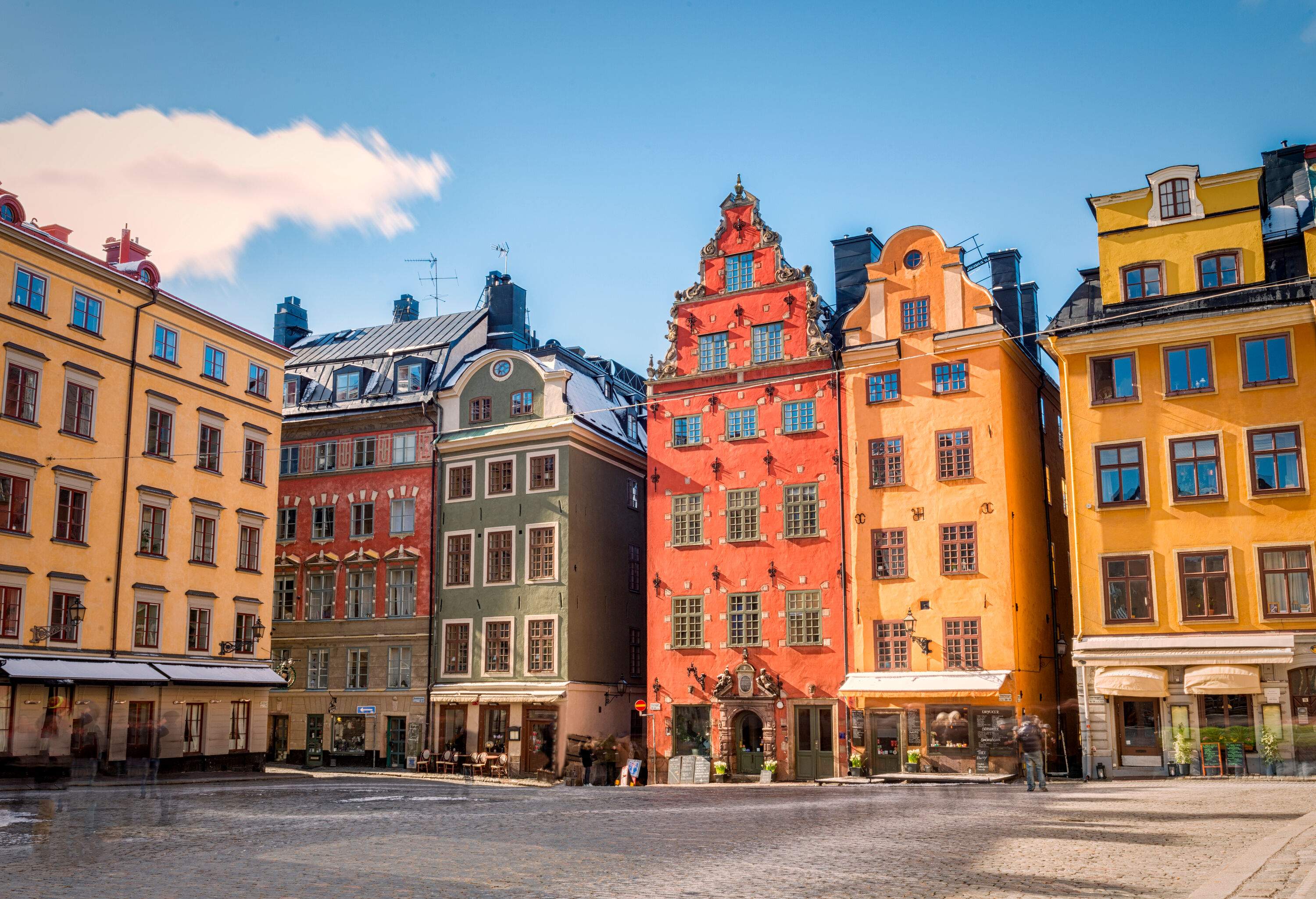 The stone-paved square is surrounded by colourful, lofty residences.