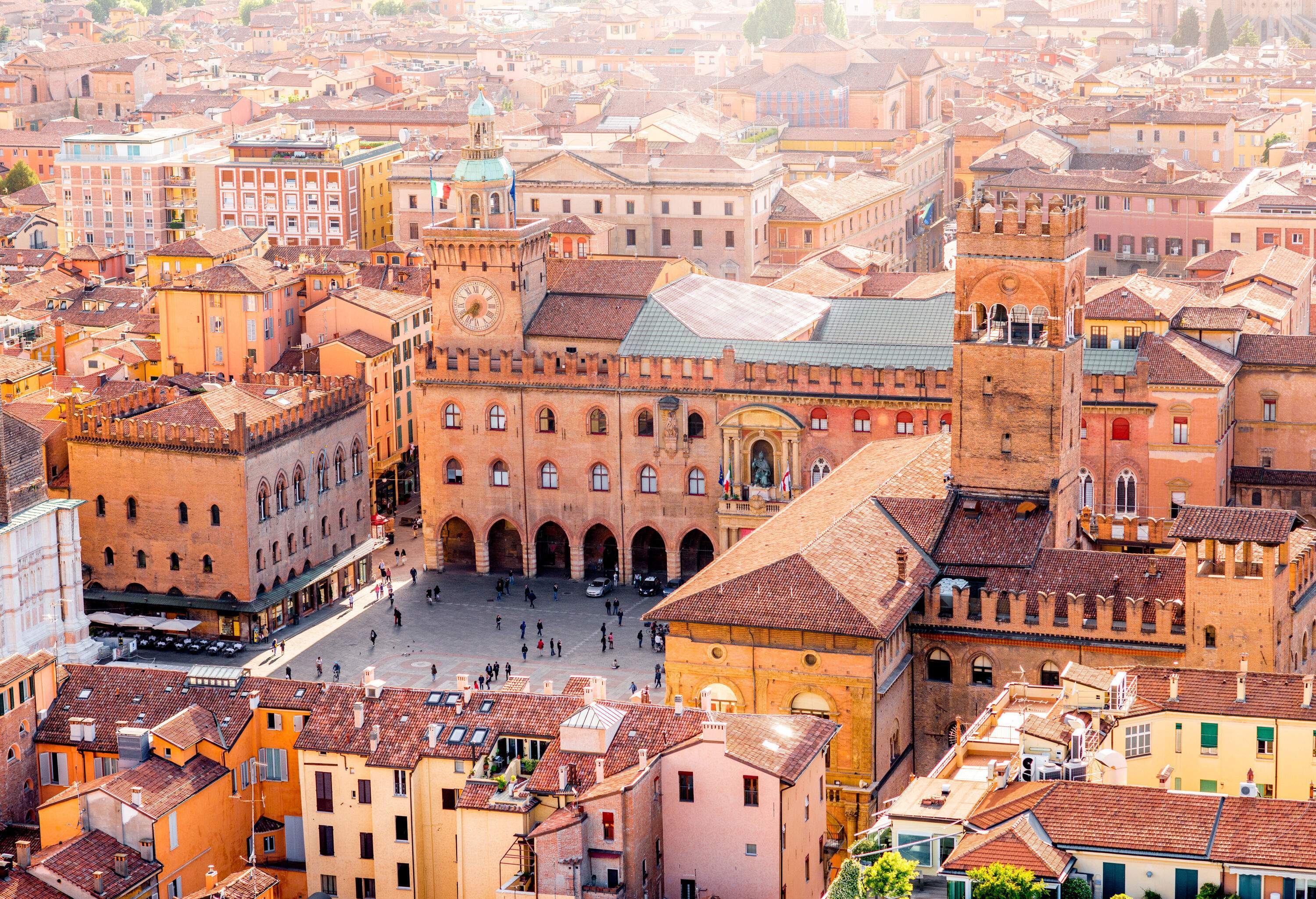 Aerial cityscape view of an old town with old buildings and a Gothic basilica in the centre of a plaza square.