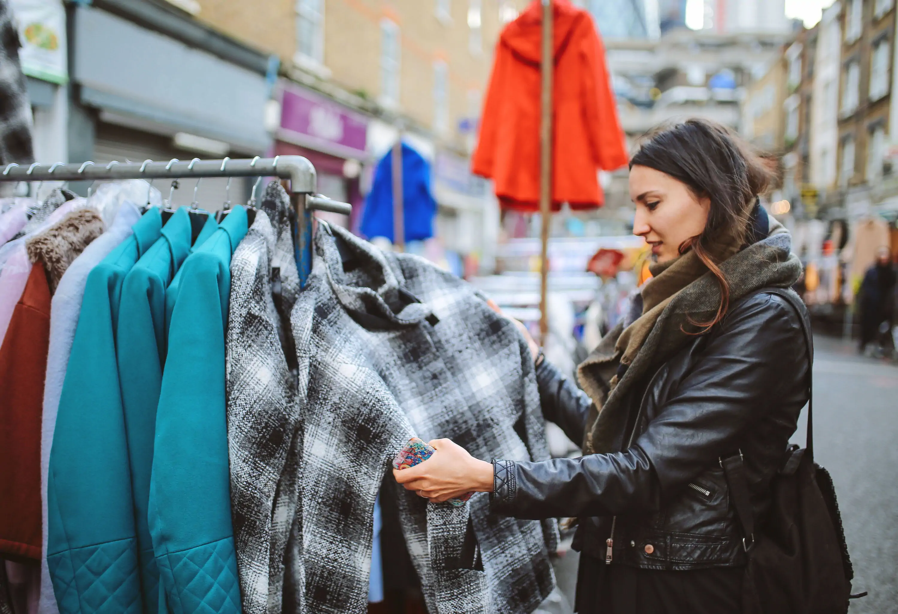 A lady checks on the coats displayed at the flea market.