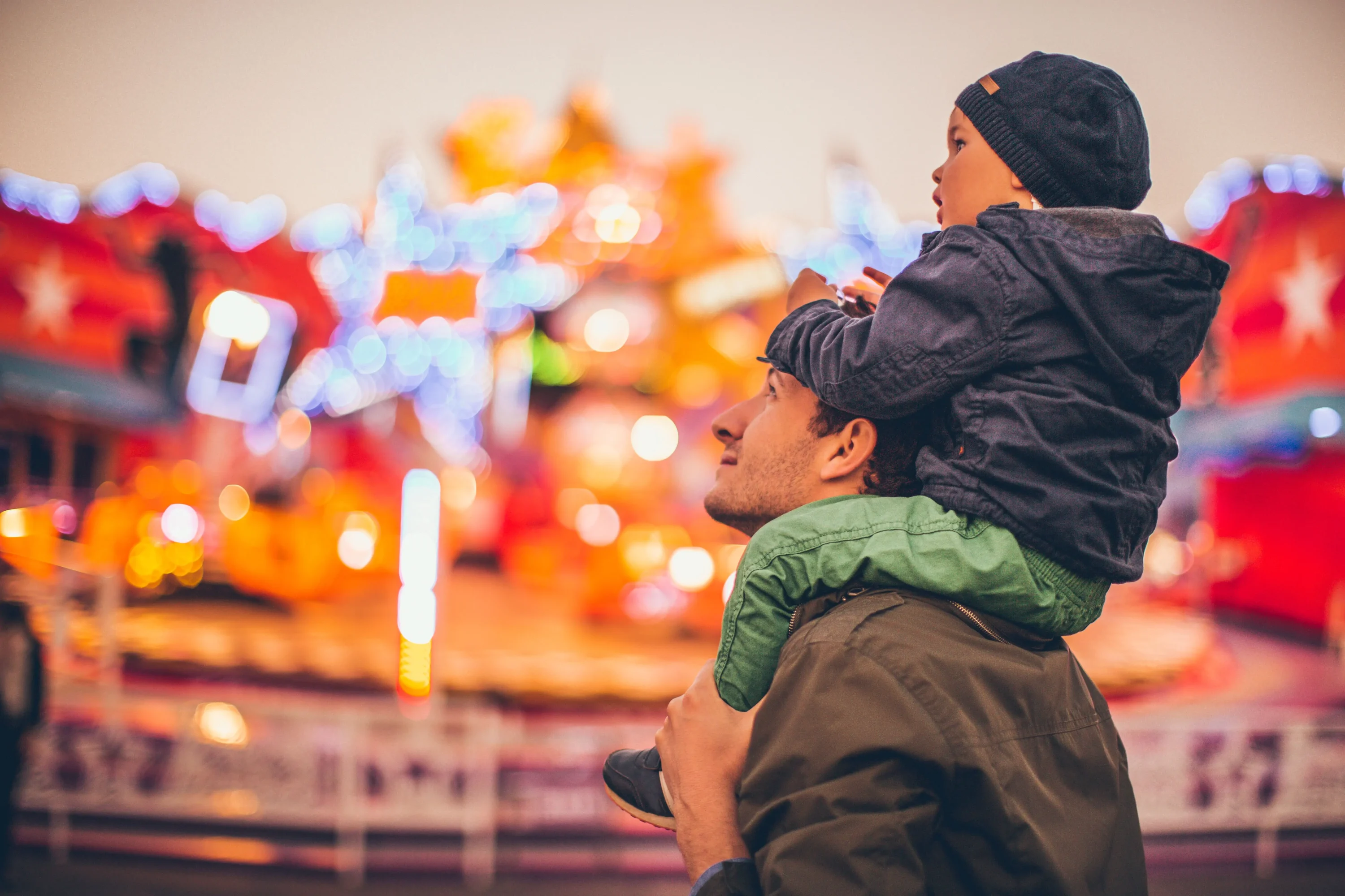 Father and son enjoy together in the amusement park.