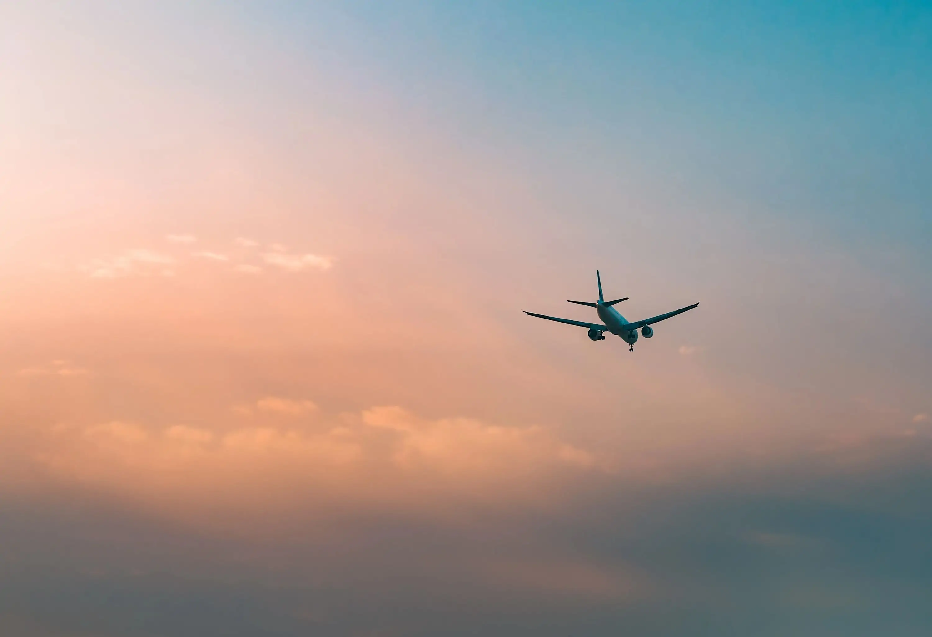 Aircraft flying over clouds, aviation sunset background, essential transport for business and travel.