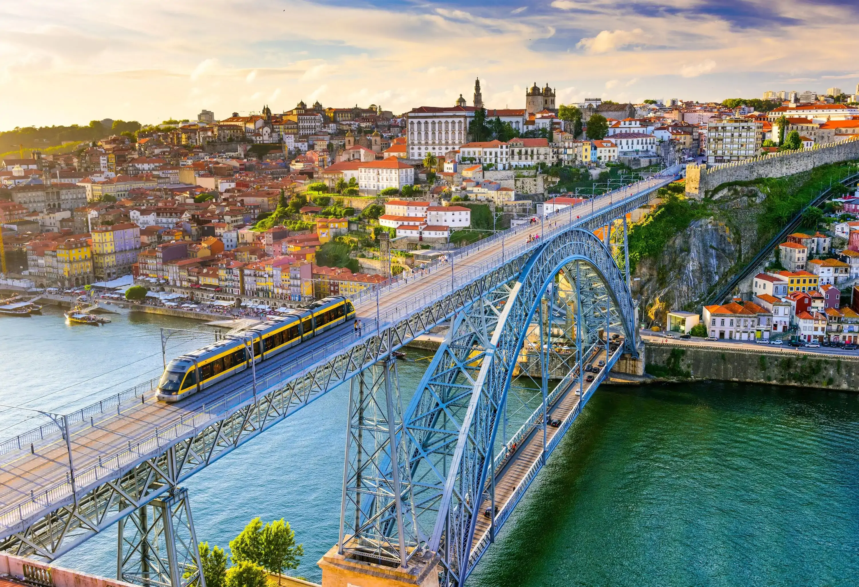 A light rail train travelling on the Dom Luís I Bridge across the River Douro.