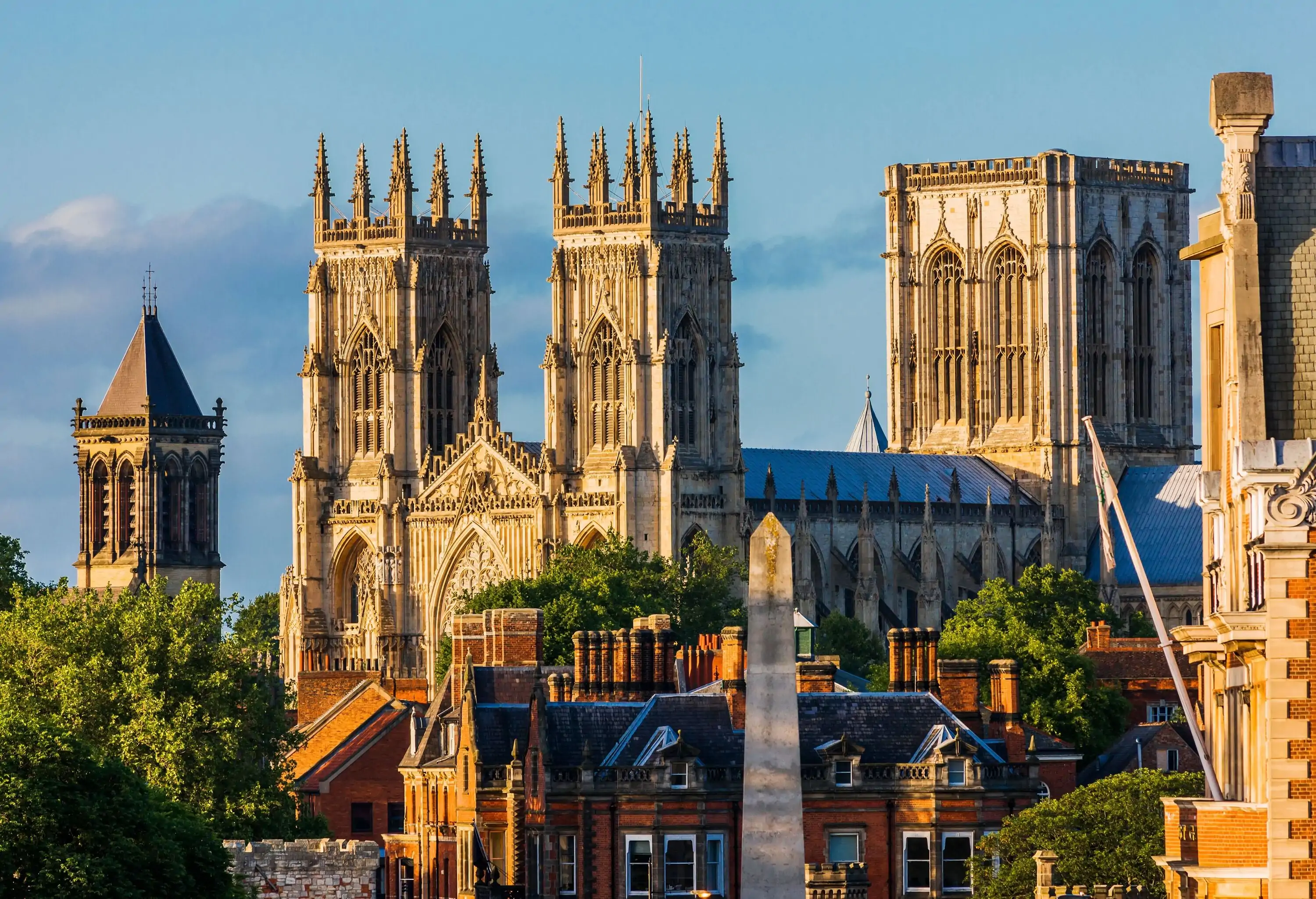 York Minster is a cathedral with a large square tower in the centre and two bell towers with elaborate pinnacles on the front.